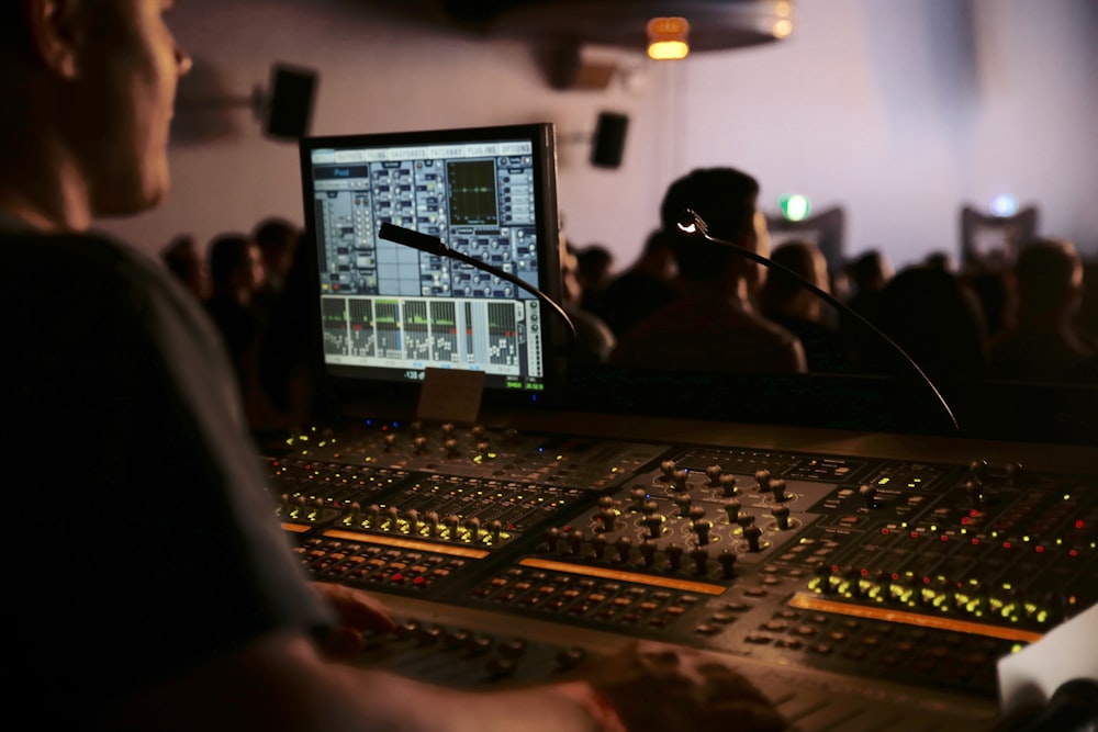 man in front of mixing console