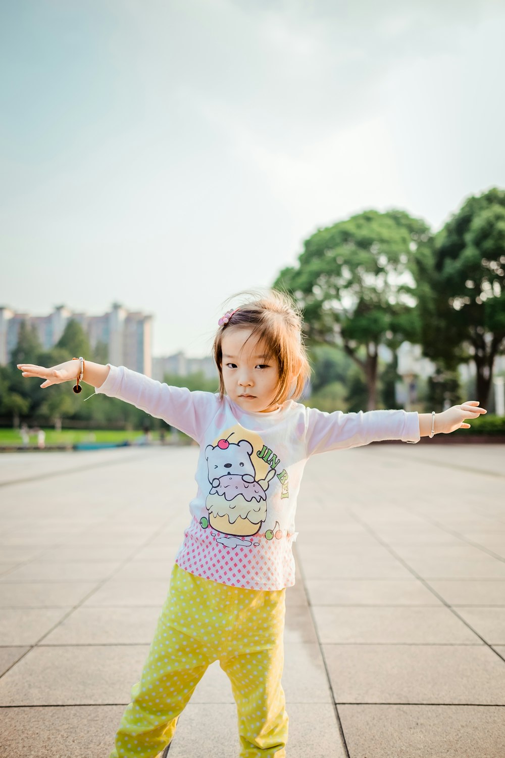 girl standing wearing white long-sleeved shirt