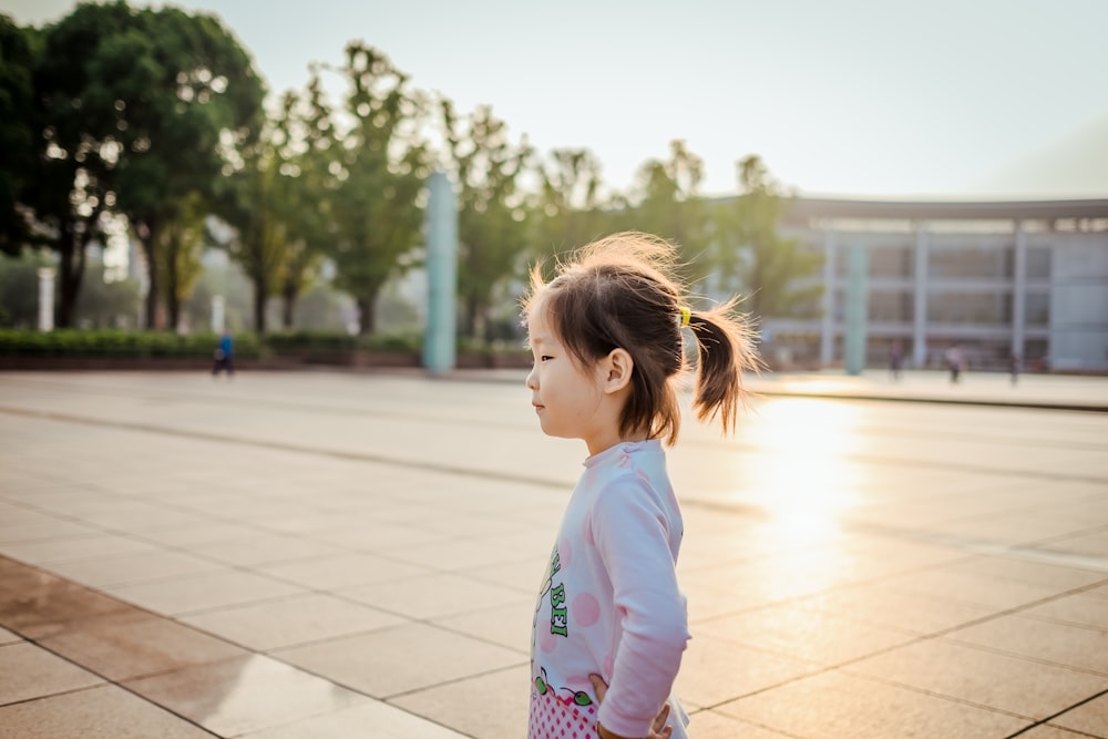 girl standing while holding her waist