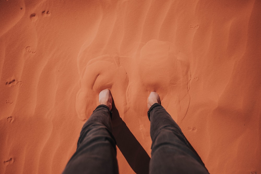 person standing on brown mud