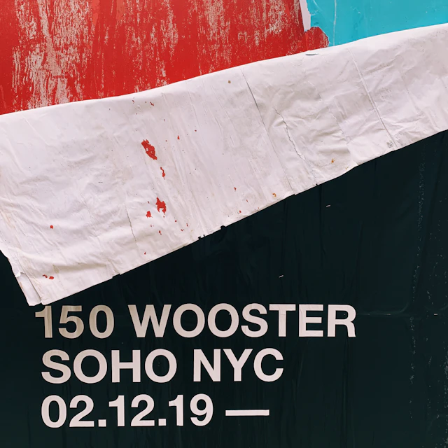 Red signage reading 150 Wooster on a building in SoHo, New York