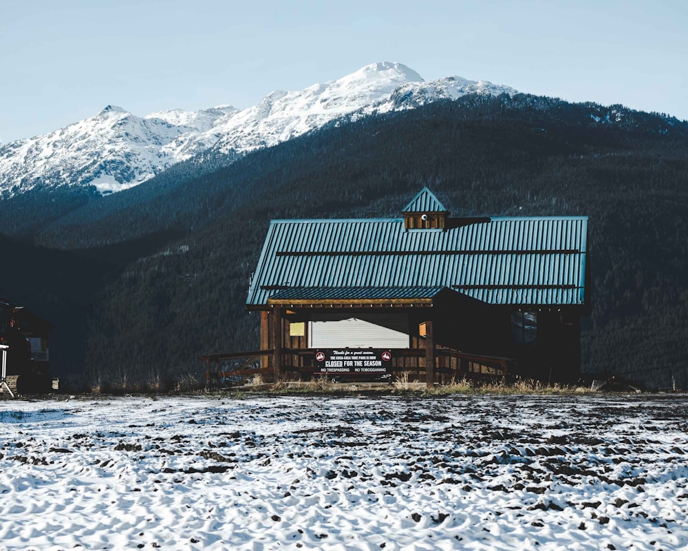 brown and blue house near mountain during daytime