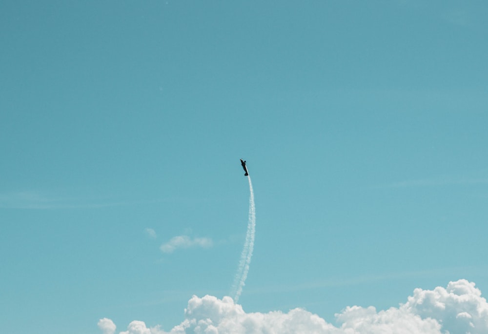 black plane under blue calm sky