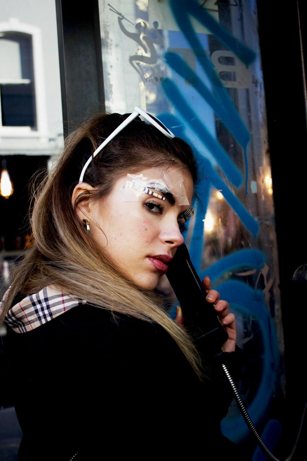 woman facing side view and using telephone