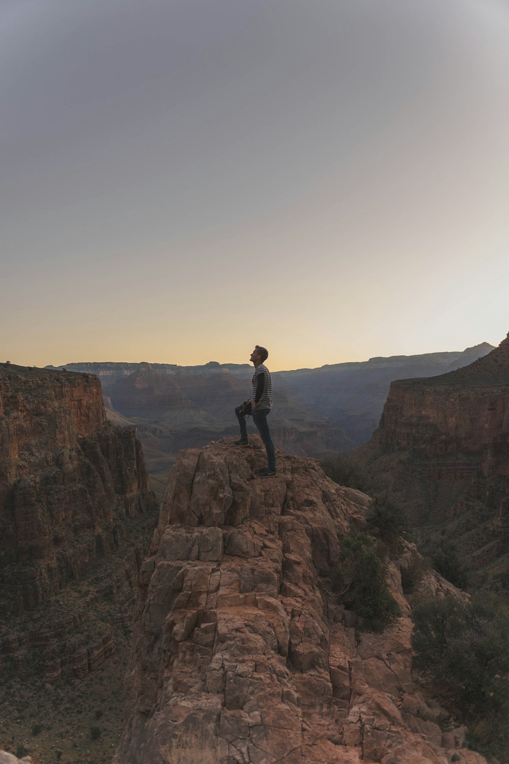 man standing on mountain cliff