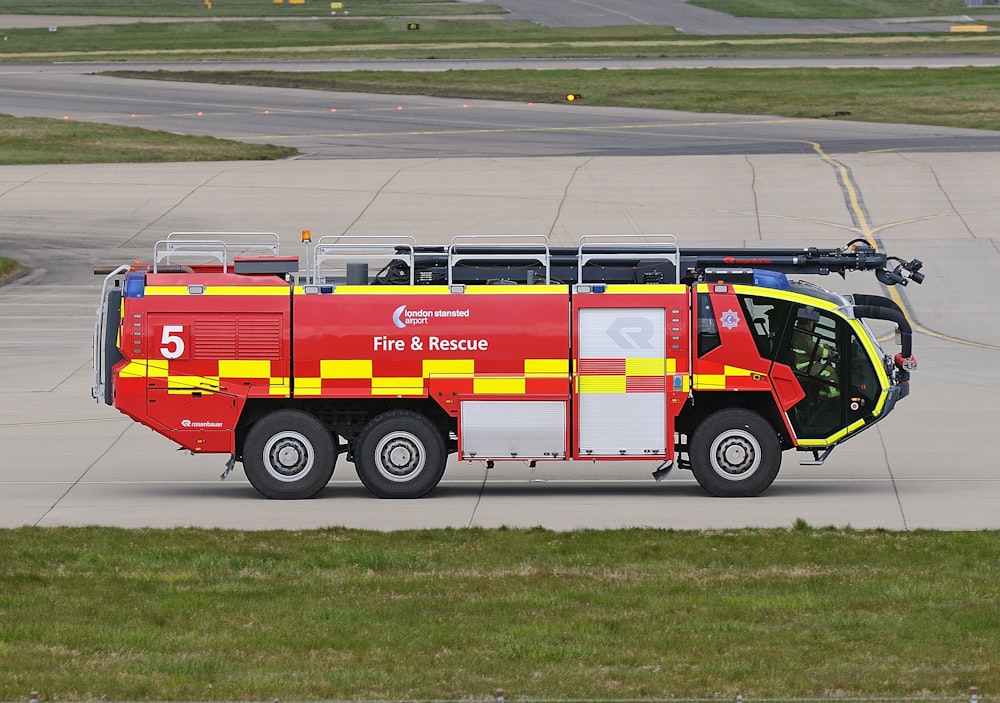 red and yellow firetruck outdoor during daytime