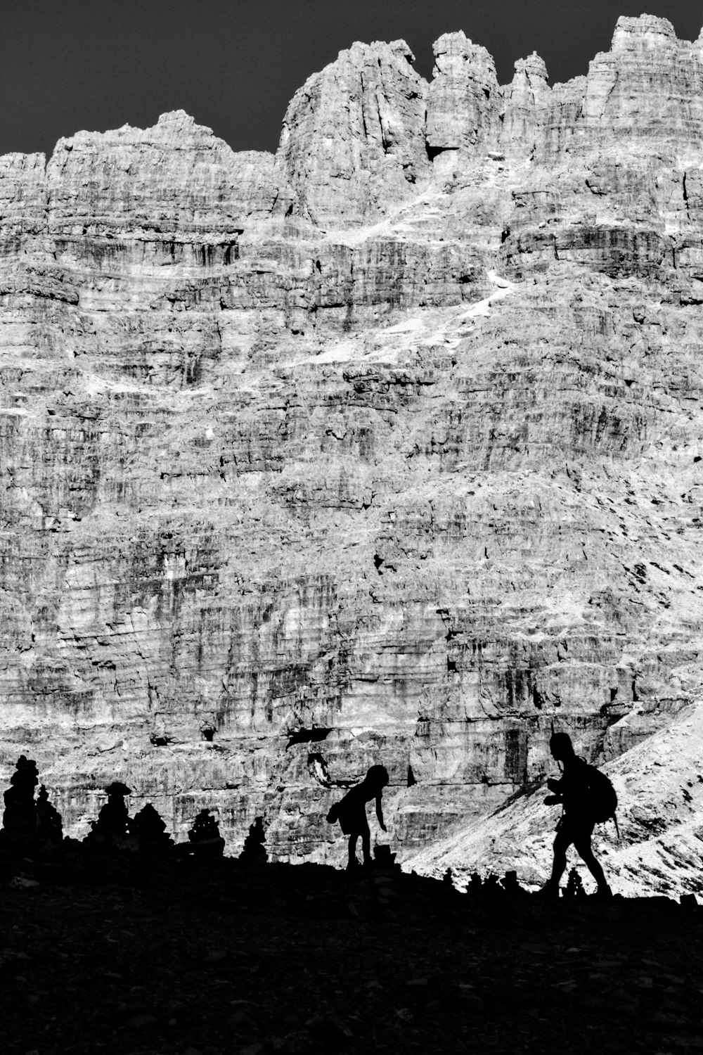 silhouette of people walking on mountain