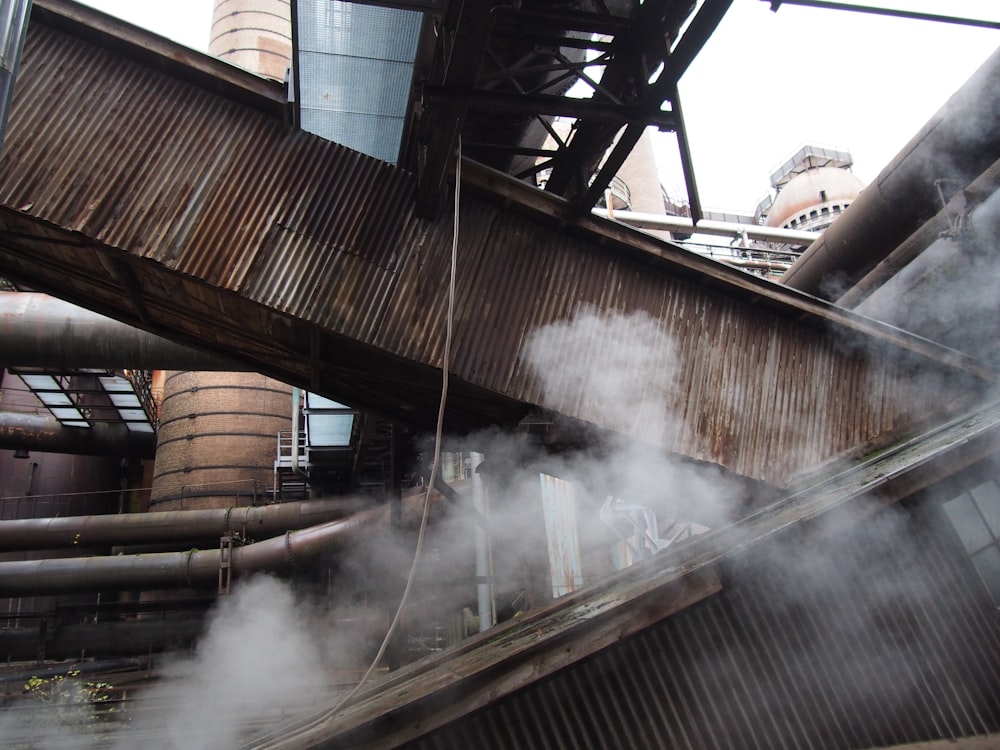 smoke coming out of the pipes of a factory