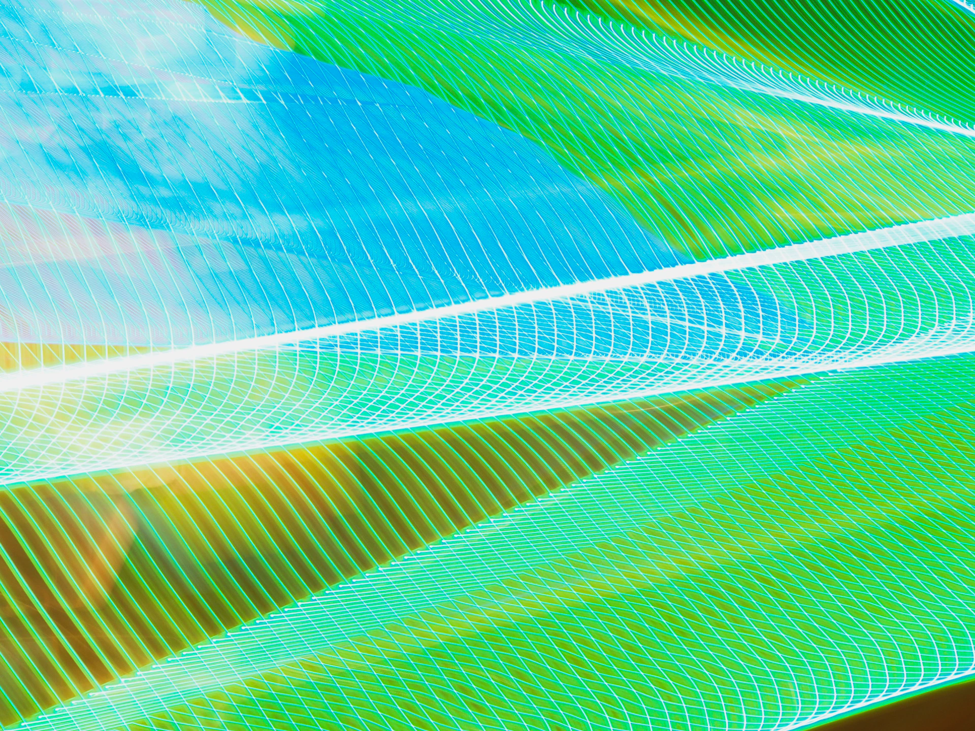 A lively, abstract representation of intersecting lines and shapes in sky blue, night blue, and small accents of green and yellow, reflecting the meeting of diverse ideas.