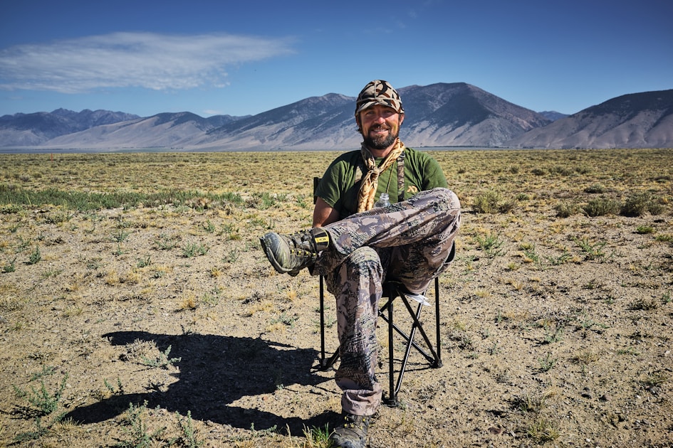 Hunter glassing a western mountain basin with multiple states' worth of hunting country visible