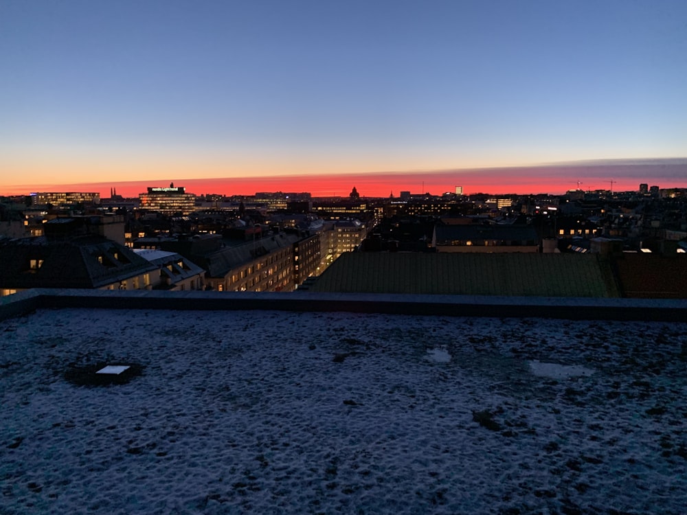 a view of a city at sunset from a rooftop