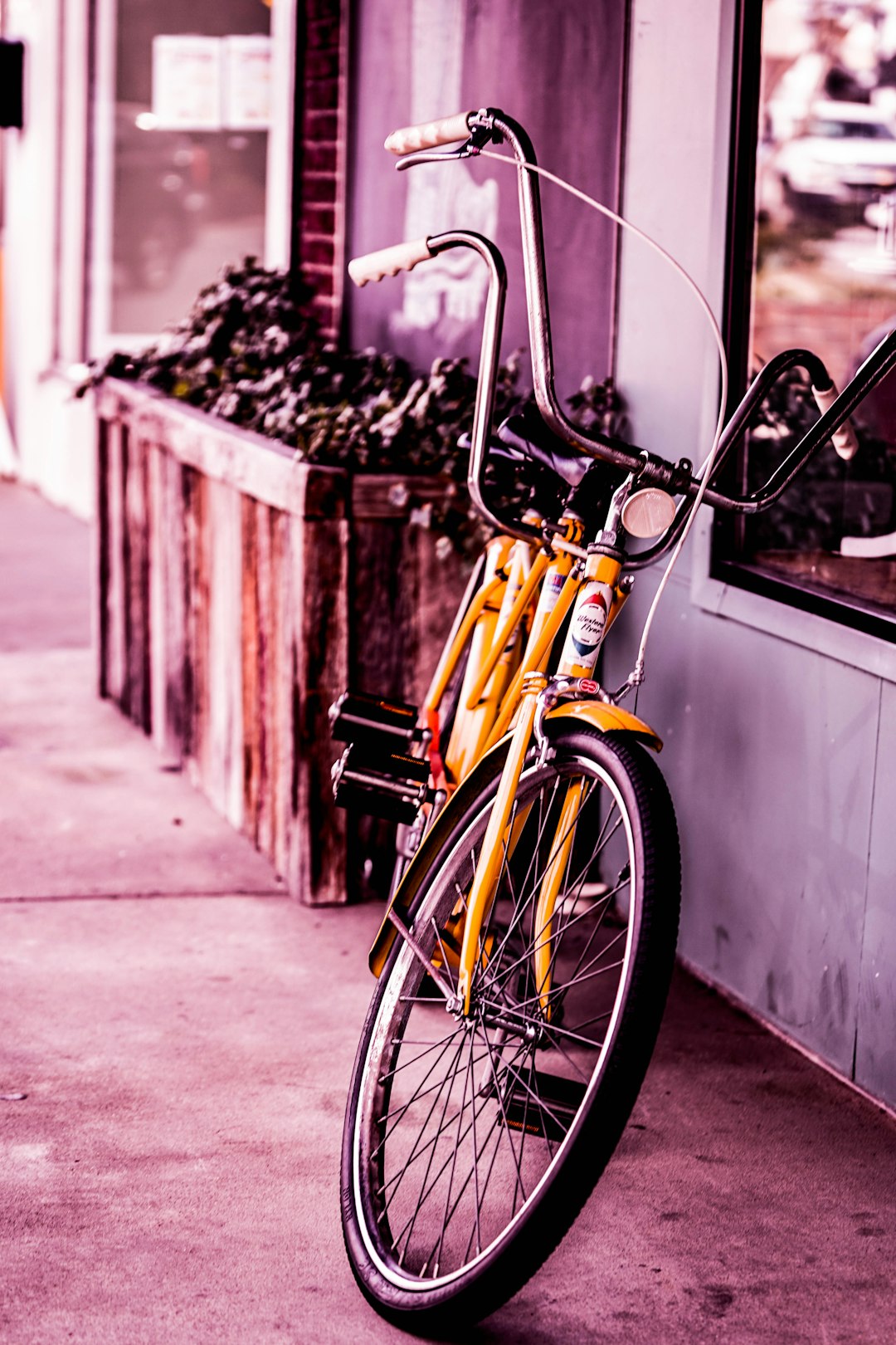 yellow city bike leaning on wall