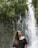woman wearing black off-shoulder top across waterfalls