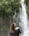 woman wearing black off-shoulder top across waterfalls