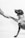 grayscale photo of person and dog holding hands