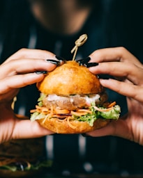 person holding burger