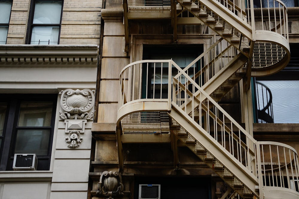 brown concrete building with metal stairs