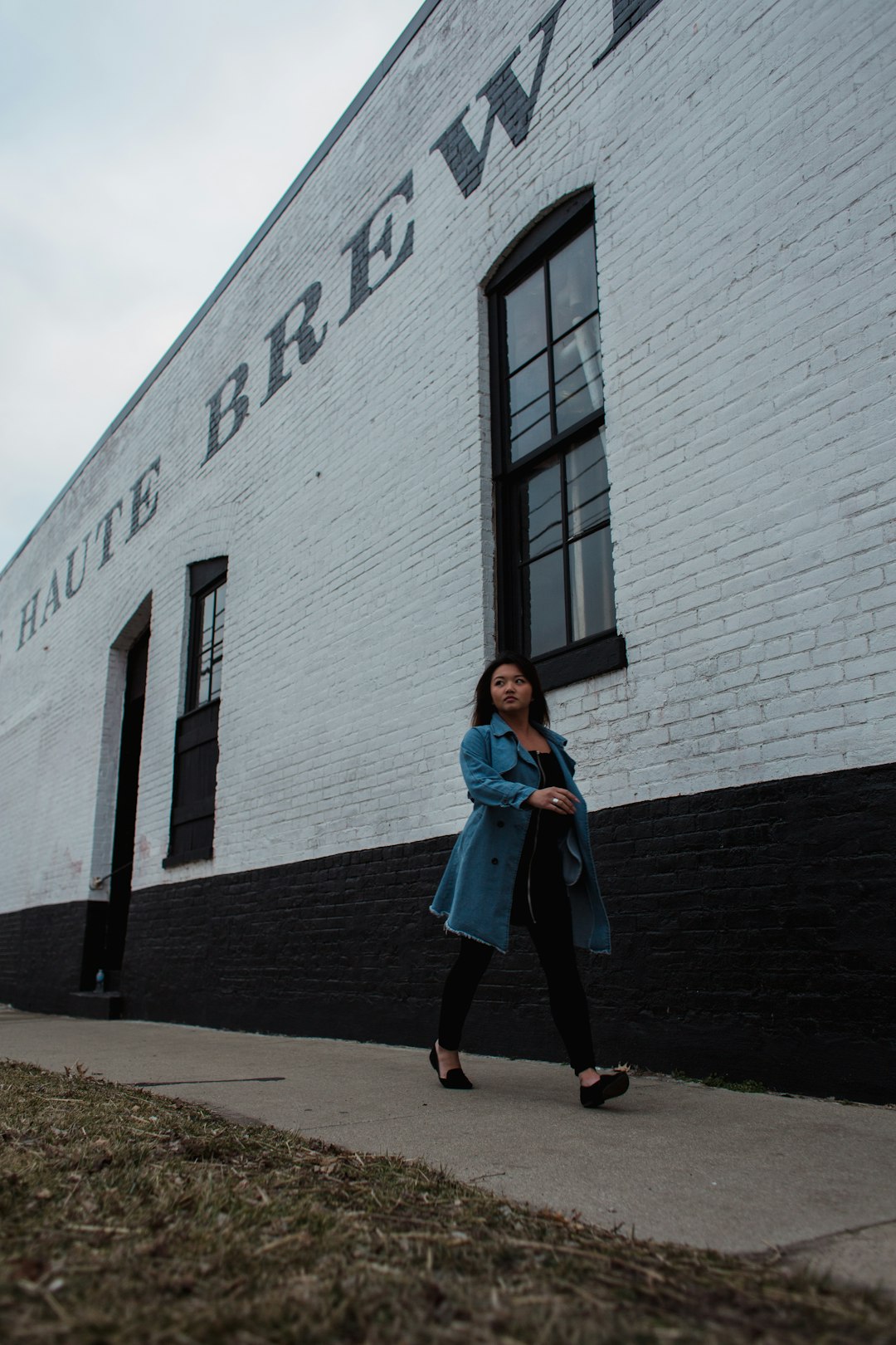 woman walking beside building