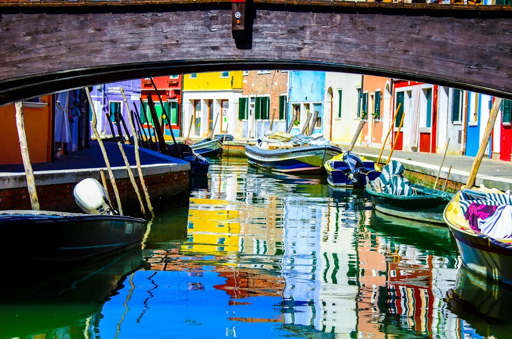 boats on river beside buildings