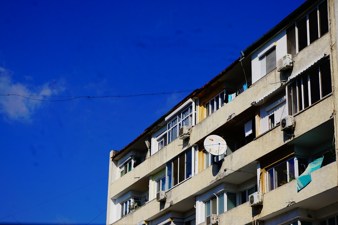 concrete building with AC units outside