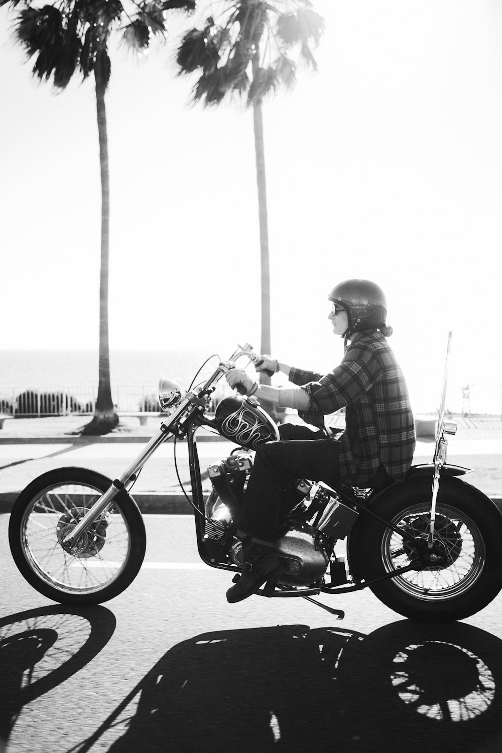 person riding on chopper motorcycle during daytime