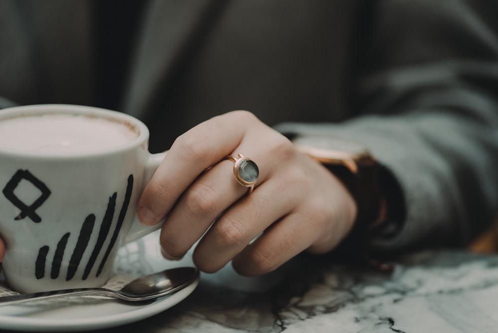 person holding mug