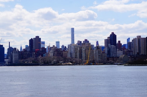 A city skyline with various real estate properties available for investment.