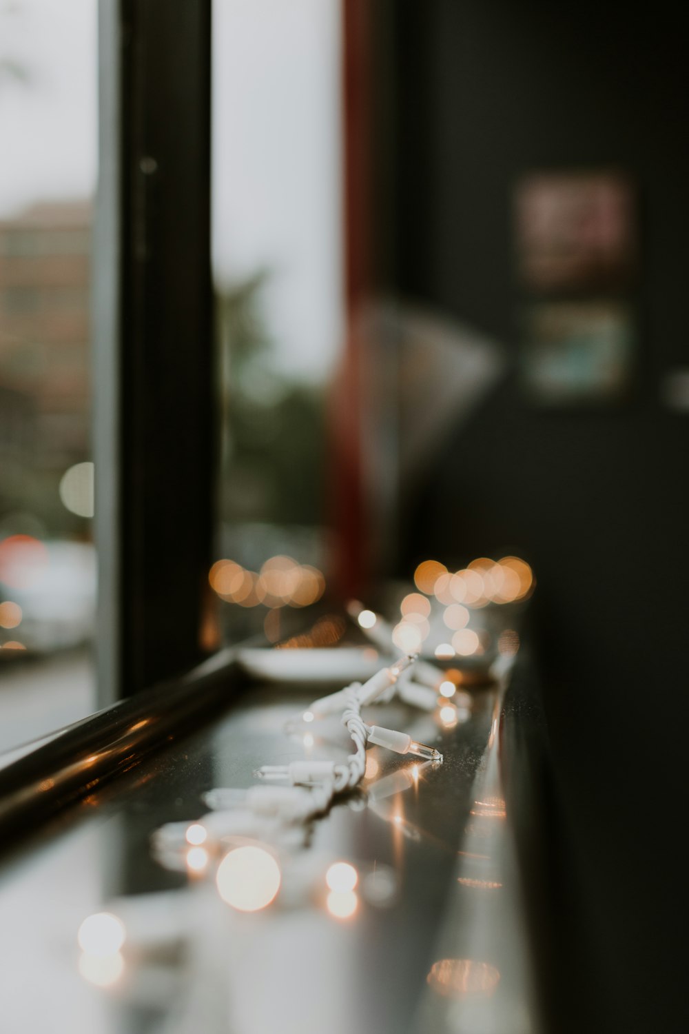 turned on string light beside window