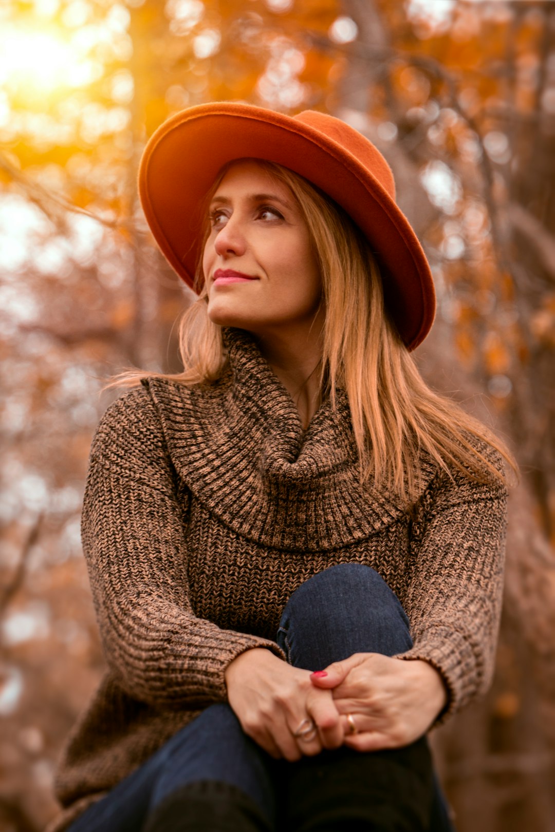 woman wearing brown sweater and orange hat