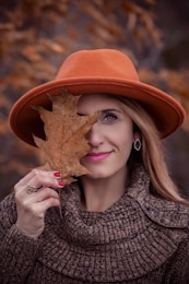 woman holding dried leaf