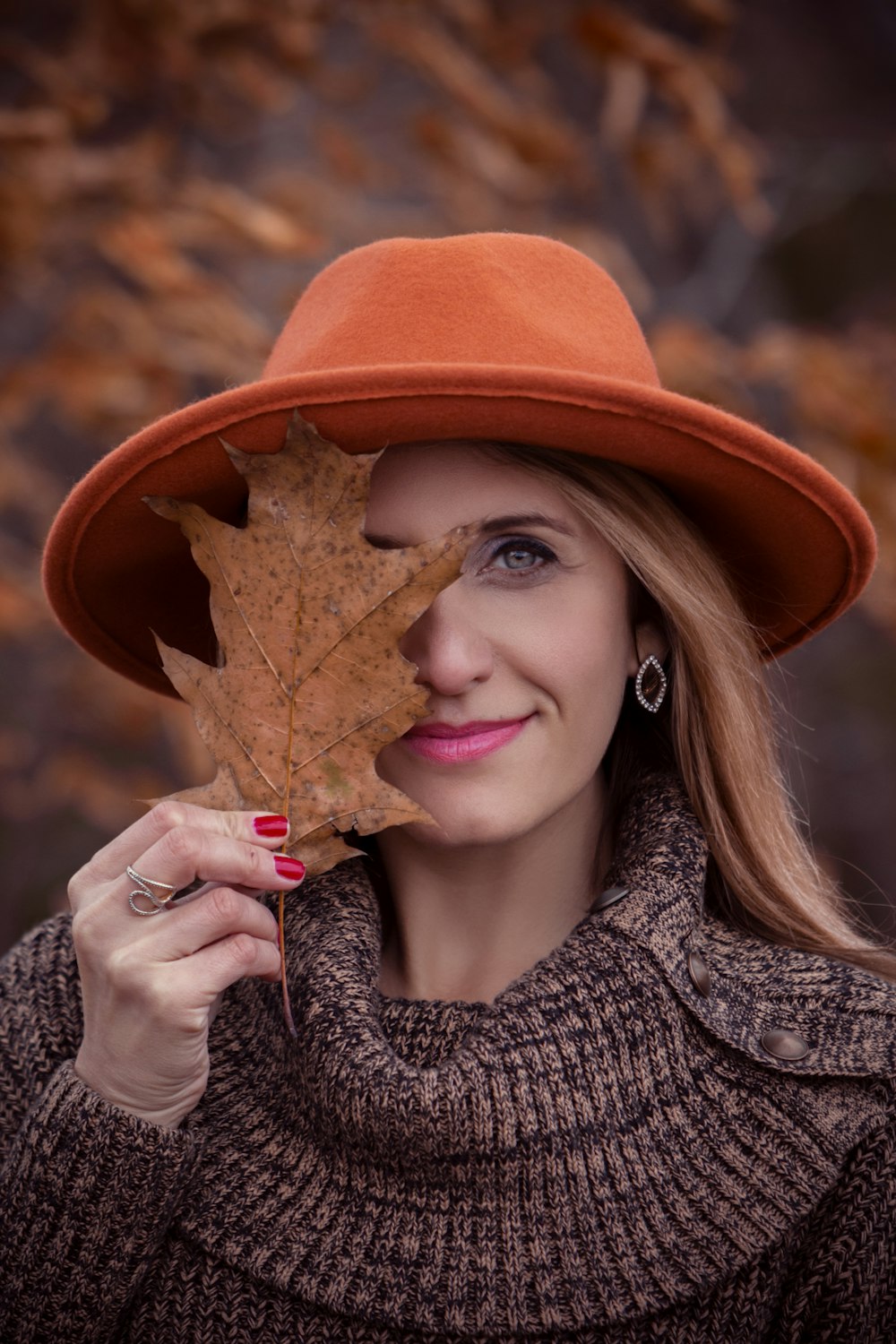 woman holding dried leaf
