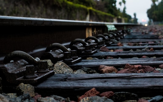 Close-up of sturdy wooden railroad sleepers laid out in a railway track.