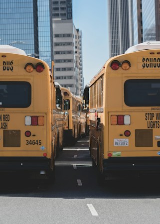 A line of school buses on the road during the day, a reminder of how many routes CCSD runs each morning