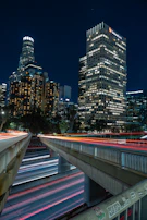 Urban skyline at night visible through studio windows, city lights framing an atmosphere of creative energy and business hustle.