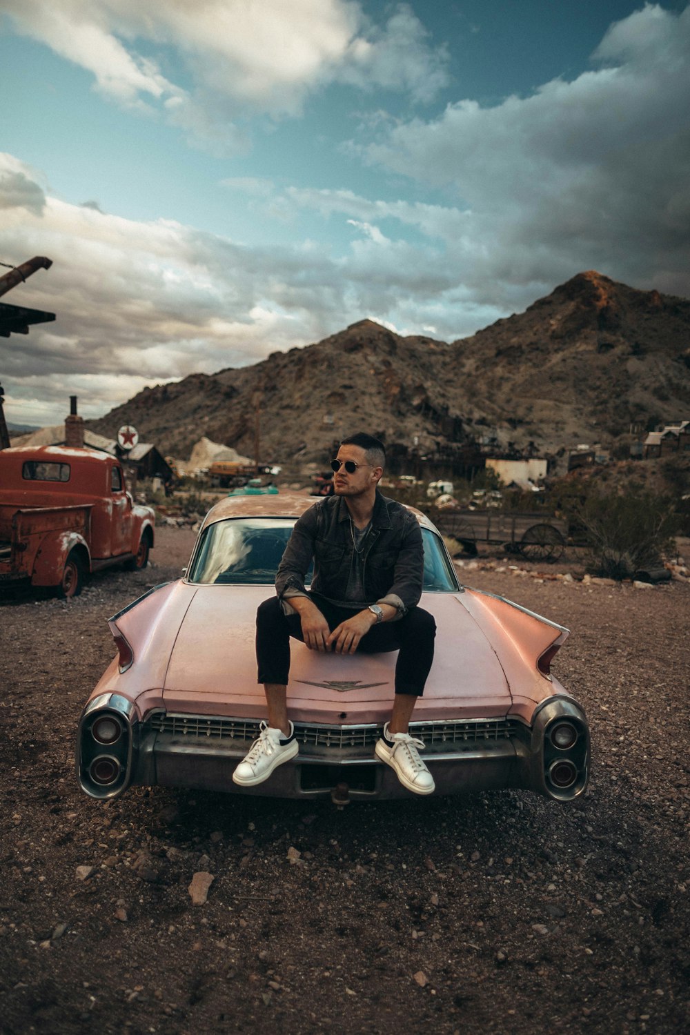 man sitting on classic car