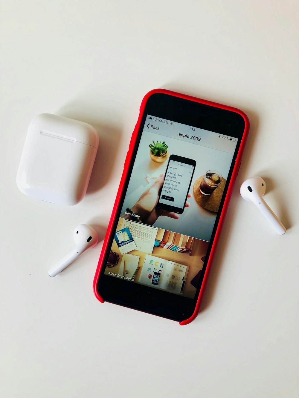 flat lay photography of iPhone beside AirPods