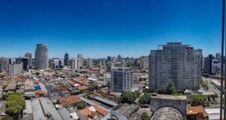 A panoramic view of a bustling Colombian city skyline with residential and commercial buildings.