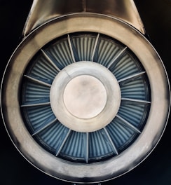 Close-up of a high-speed turbine rotor spinning inside a sleek industrial casing.
