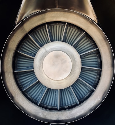 Close-up of a high-speed turbine rotor spinning inside a sleek industrial casing.