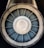 A close-up view of a jet engine turbine, displaying the concentric metallic blades and central hub with a symmetrical pattern.