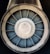 A close-up view of a jet engine turbine, displaying the concentric metallic blades and central hub with a symmetrical pattern.