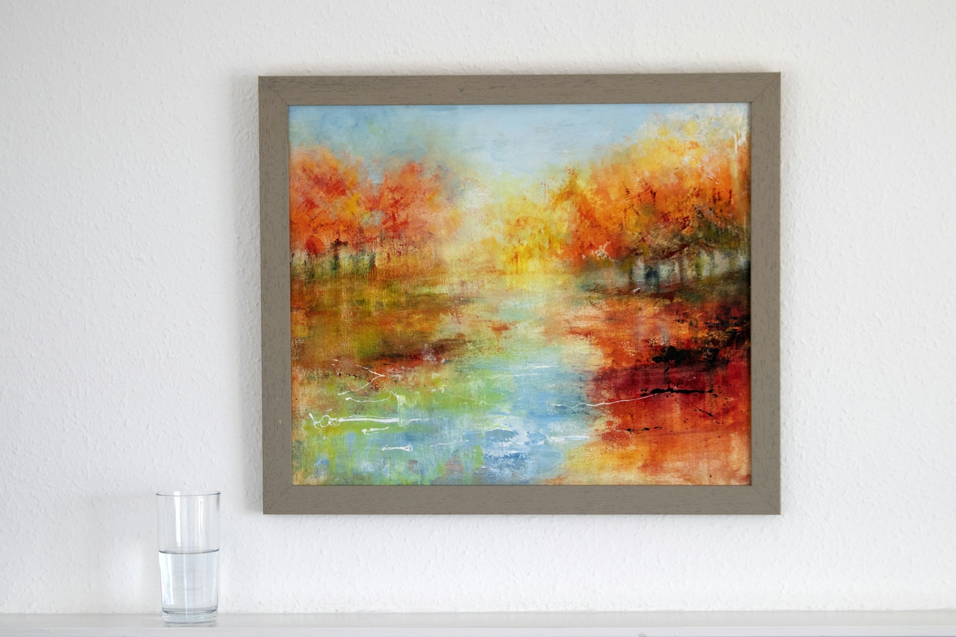 a painting hanging on a wall above a fireplace