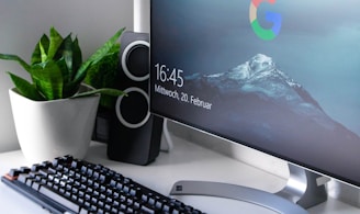 black Logitech G710+ wireless keyboard and wireless mouse near gray flat screen computer monitor on table