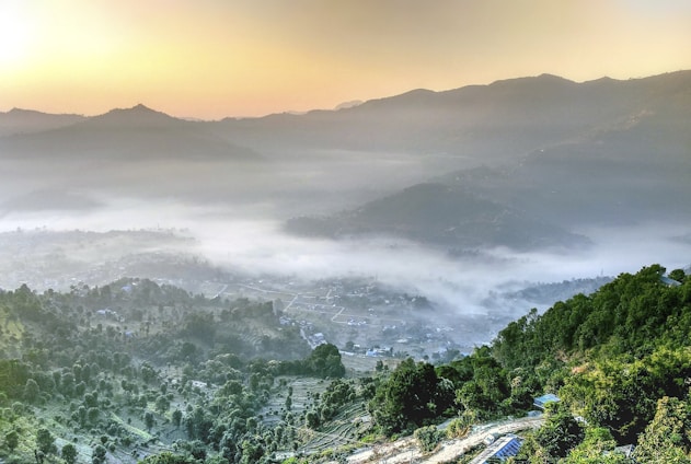 A panoramic view of the Great Smoky Mountains at sunrise with mist rolling over the peaks.
