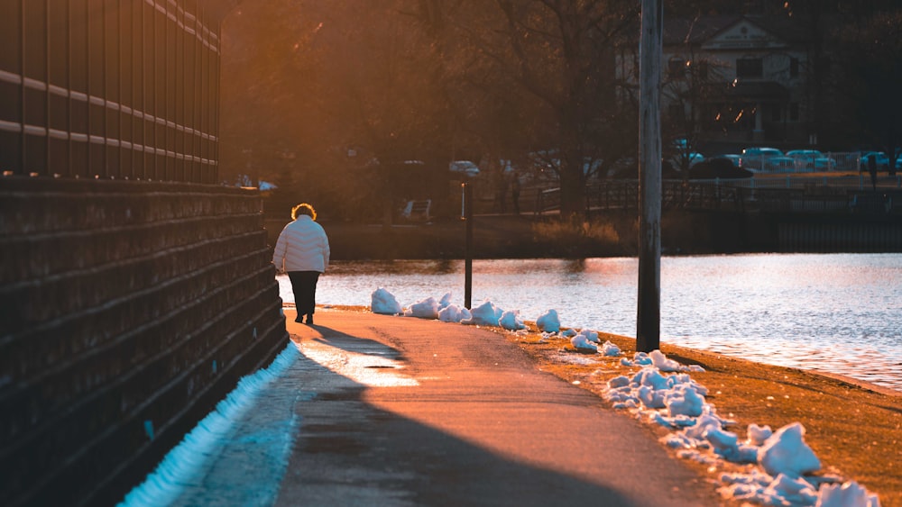 woman walking along side of the lake