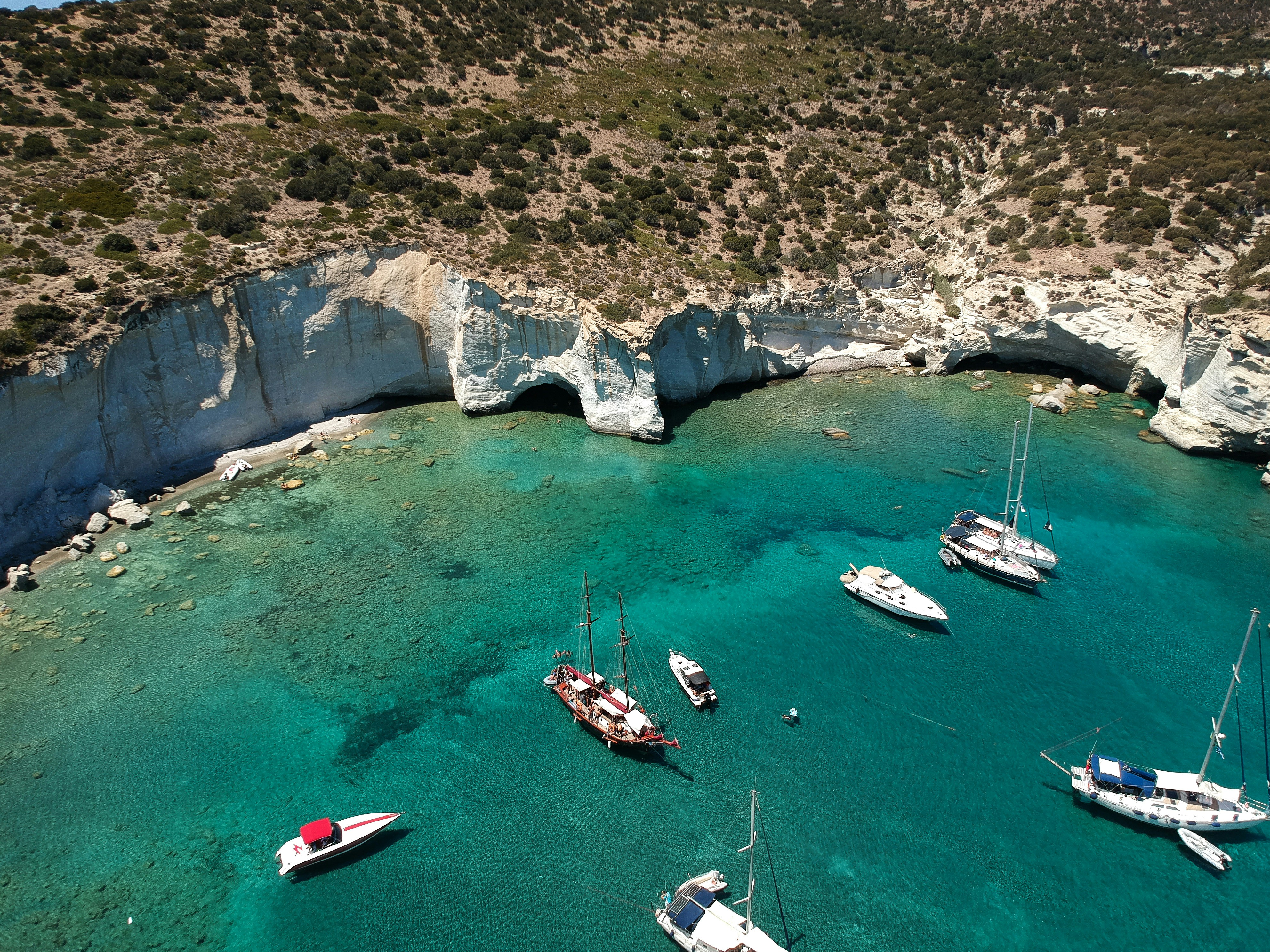 a group of boats floating on top of a body of water