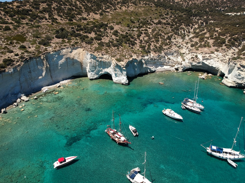 a group of boats floating on top of a body of water