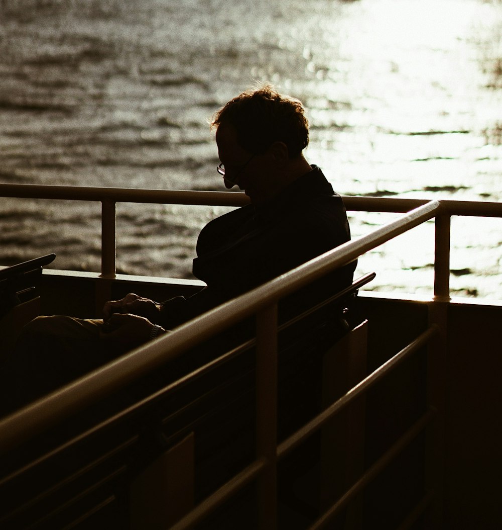 silhouette photography of man sitting