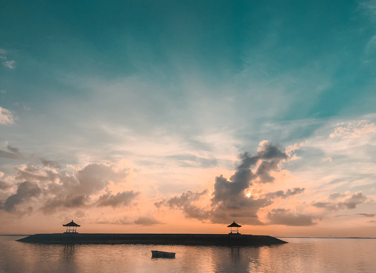 Peaceful sunrise bicycle boardwalk and calm barrier reef shallows in Sanur
