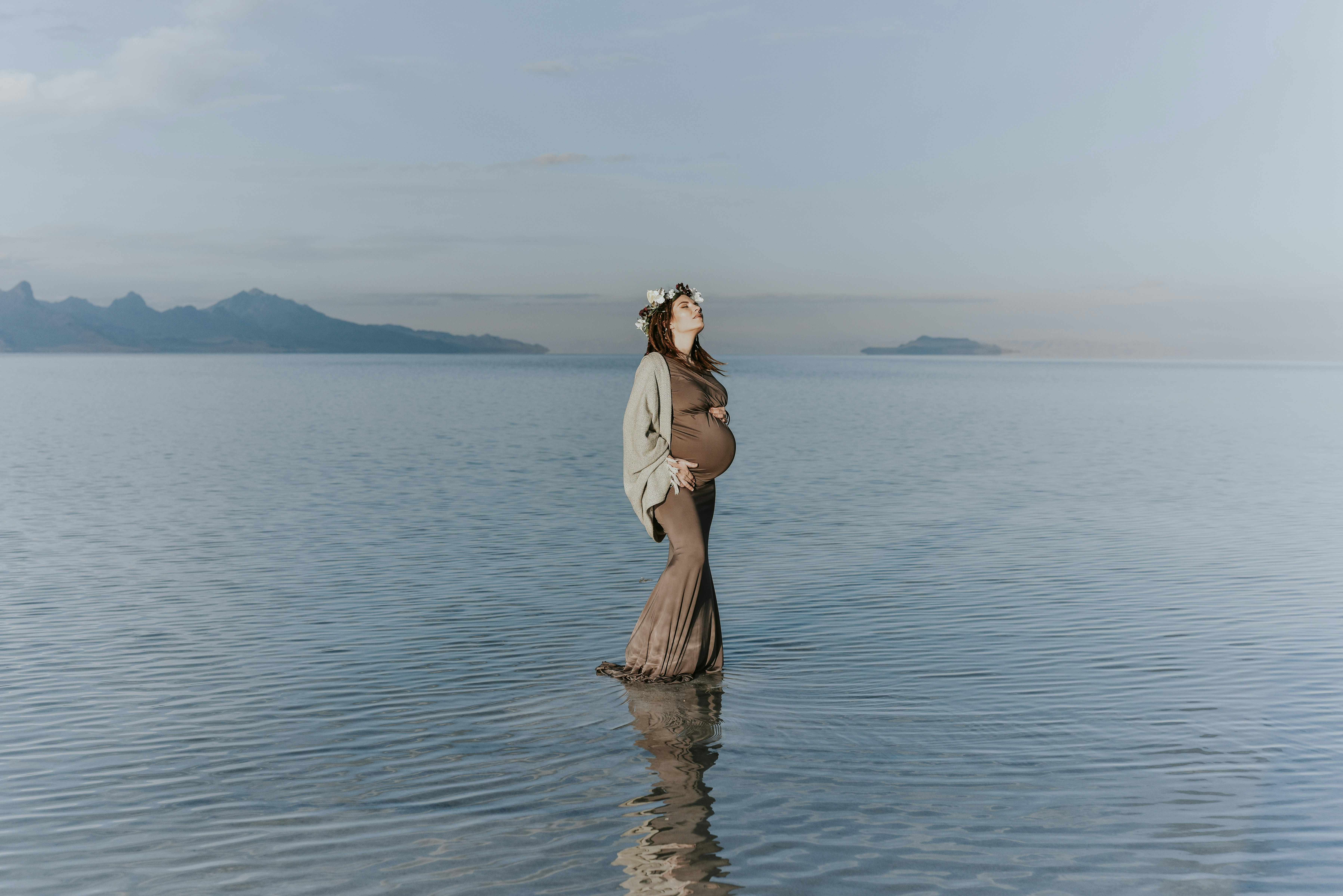 woman wearing brown dress surrounded by water